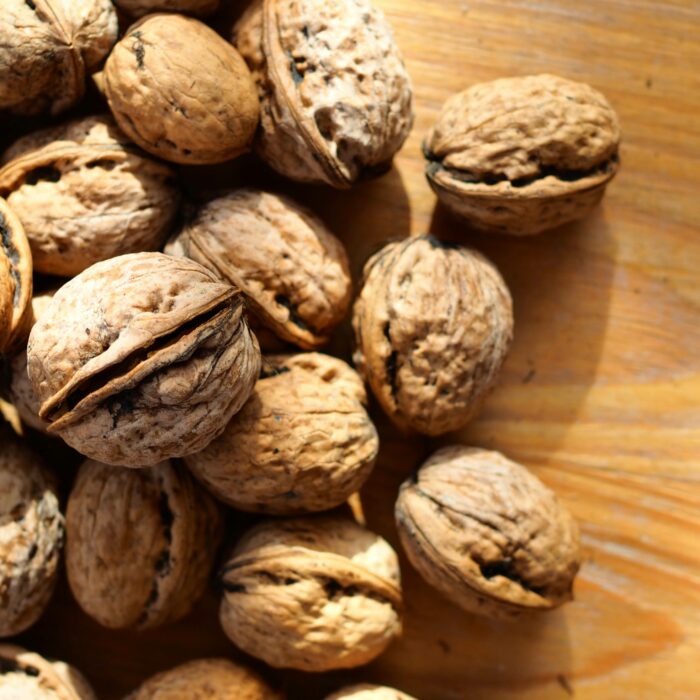 A pile of Brazil nuts on a wooden surface